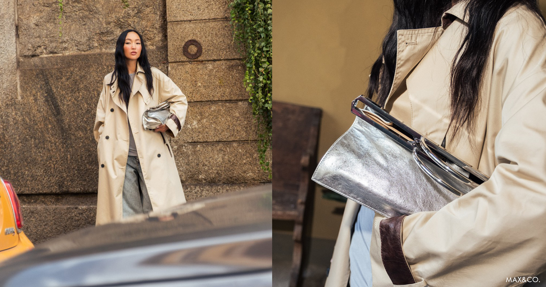 A woman in a beige trench coat stands by an urban stone wall, holding a metallic bag, embodying contemporary street style.